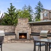 patio with seating fire pit and grills