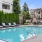 a swimming pool with chairs and tables