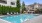 a swimming pool with chairs and tables