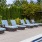 a pool with chairs and umbrella