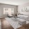 a living room with a white couch and a tv